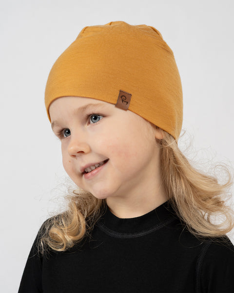Kids merino wool beanie in mustard yellow, soft breathable hat for warmth and everyday wear.