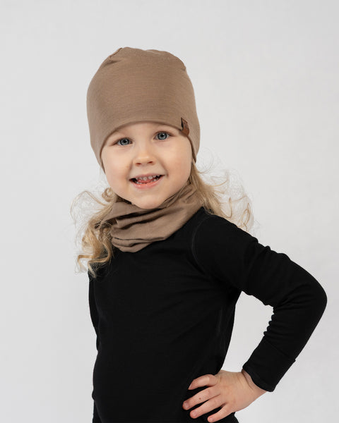 Kids merino wool beanie and neck gaiter set in beige, comfortable and breathable cold weather gear.