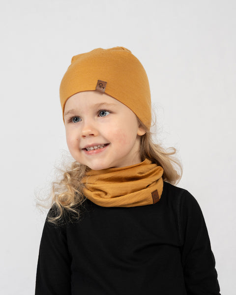 Kids merino wool beanie and neck gaiter set in mustard yellow, soft thermal accessories for outdoor wear.