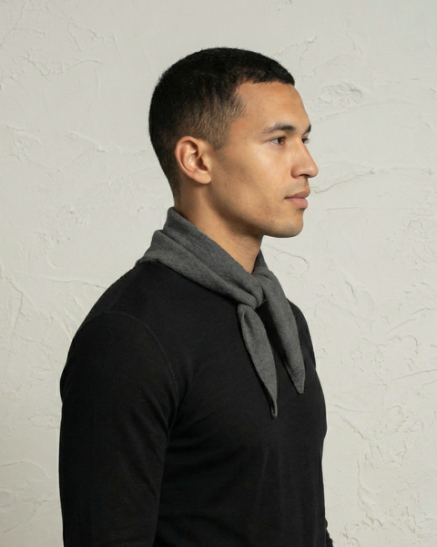 Man wearing a gray cashmere merino knit bandana scarf styled around the neck