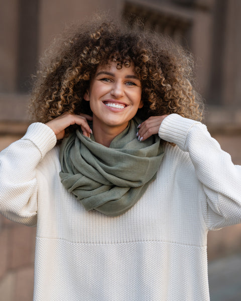 Curly hair woman wearing linen scarf in stone green color