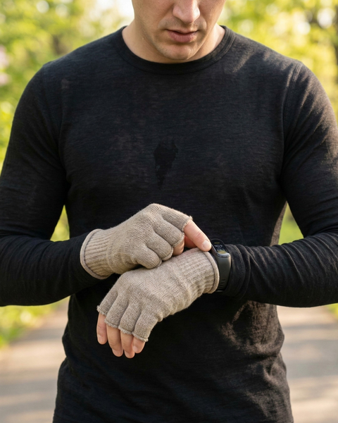 Close-up of men’s beige merino wool fingerless gloves allowing smartwatch use, breathable lightweight spring gloves for running, cycling, and outdoor activities