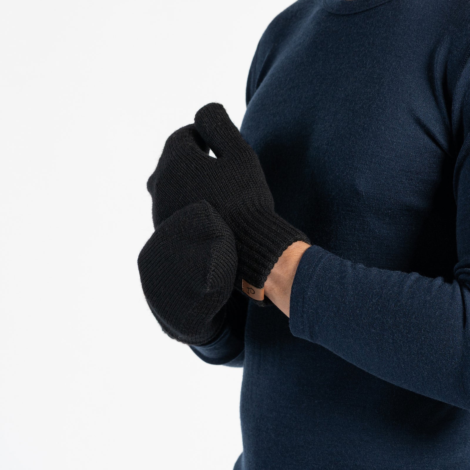 Black knit glove with a brand label on a white background