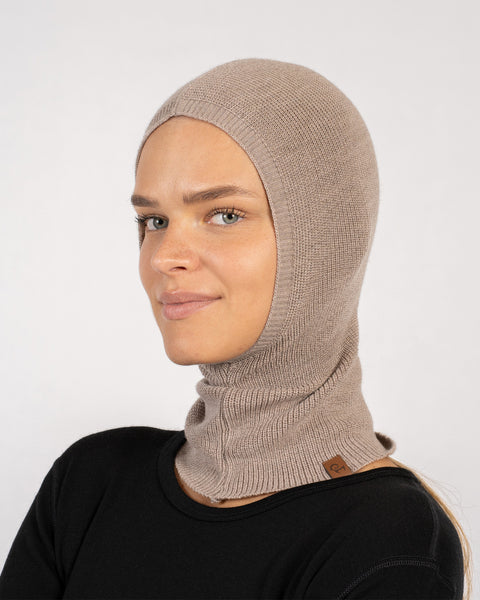 Woman in a creamy beige knitted Merino wool balaclava, full head and neck coverage.