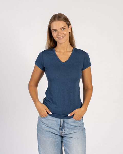 Woman smiling in a denim blue Merino wool V-neck short sleeve T-shirt.