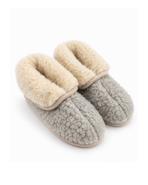 An angled view of light gray, fuzzy slipper booties with a thick, plush beige lining visible at the ankle opening.