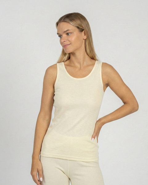 Woman wearing natural Merino wool tank top and leggings, breathable thermal underwear for layering