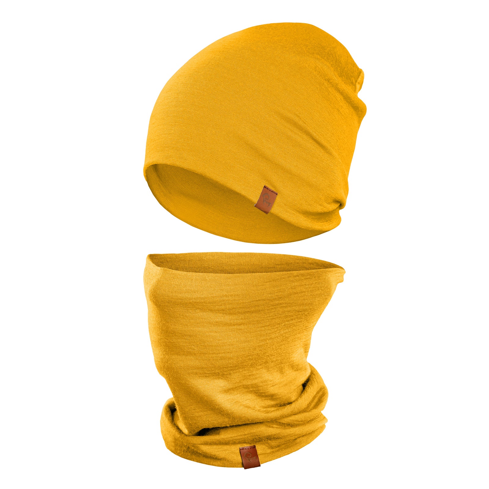 A person with light eyes is wearing a spicy yellow menique beanie that is pulled down to cover part of their forehead and a matching neck gaiter that is pulled up to cover their mouth and nose. They are wearing a dark long-sleeved shirt, and the blurred background suggests an outdoor setting with trees and foliage in muted tones.