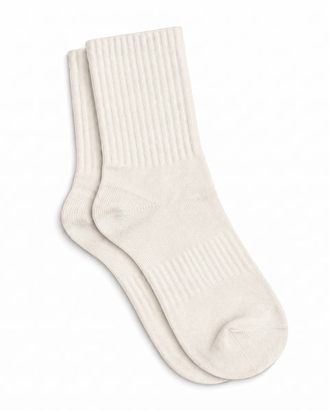 A pair of natural off-white, ribbed crew socks lying flat against a plain white background.