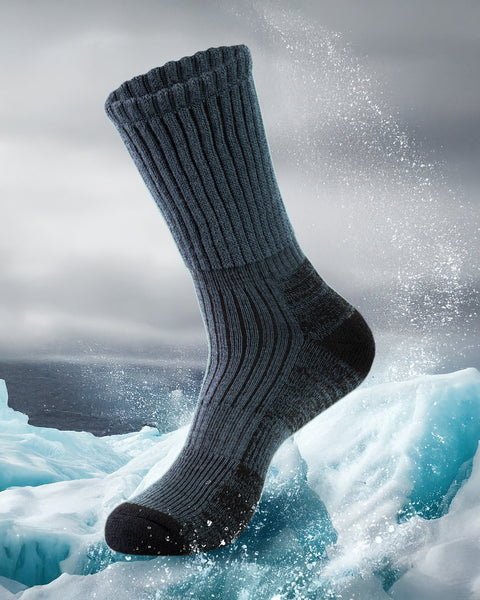 Dark gray sock emerging from a snowy landscape with water splashing around