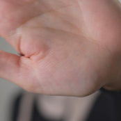 Video of a model wearing a merino wool knit bandana, highlighting bandana's design.